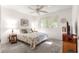 Bright bedroom featuring a ceiling fan, large window, and decorative accents at 9638 Sw 94Th Ave # C, Ocala, FL 34481
