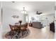 Open-concept dining area with stylish seating, a round glass table, and seamless flow to the living room at 9638 Sw 94Th Ave # C, Ocala, FL 34481