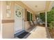 Inviting front porch with seating, decorative wreath, and neutral tones creating a warm welcome at 9638 Sw 94Th Ave # C, Ocala, FL 34481