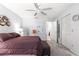 Main bedroom with ceiling fan, walk-in closet, and calming color palette at 9638 Sw 94Th Ave # C, Ocala, FL 34481
