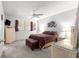 Spacious main bedroom with ceiling fan, stylish decor, and plush carpeting at 9638 Sw 94Th Ave # C, Ocala, FL 34481