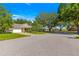 Scenic street view of homes with mature trees and green lawns in a quiet, residential neighborhood at 9638 Sw 94Th Ave # C, Ocala, FL 34481