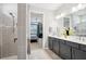 En suite bath showcasing a gray vanity with double sinks, and a glass-enclosed shower at 8875 Sw 58Th Street Rd, Ocala, FL 34481
