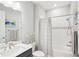 Modern bathroom features subway tile shower with tub, a gray vanity, and stylish fixtures at 8875 Sw 58Th Street Rd, Ocala, FL 34481