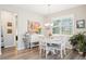 Bright dining area with a white table and chairs, and a large painting on the wall at 8875 Sw 58Th Street Rd, Ocala, FL 34481