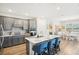 Kitchen with an island, stainless steel appliances, gray cabinets, and breakfast bar seating at 8875 Sw 58Th Street Rd, Ocala, FL 34481