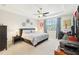 Primary bedroom boasts a ceiling fan, decor, and natural light from a window at 8875 Sw 58Th Street Rd, Ocala, FL 34481