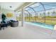 Comfortable outdoor seating area beside the screened-in pool offering a relaxing and private space at 8875 Sw 58Th Street Rd, Ocala, FL 34481