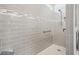 Shower with light gray tiles, integrated bench, niche, showerhead, and grab bar at 8875 Sw 58Th Street Rd, Ocala, FL 34481