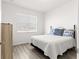 Clean bedroom with a window and wood floors at 10589 Sw 98Th Ln, Ocala, FL 34481