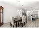 Dining room features wood floors and chandelier at 10589 Sw 98Th Ln, Ocala, FL 34481