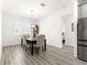 Dining room features wood floors and chandelier at 10589 Sw 98Th Ln, Ocala, FL 34481
