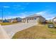 Exterior view of a house with a stone driveway, well-maintained lawn, and a two-car garage at 10589 Sw 98Th Ln, Ocala, FL 34481