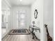 Elegant foyer featuring hardwood floors, decorative glass doors, and a stylish console table at 10589 Sw 98Th Ln, Ocala, FL 34481