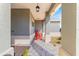 Charming covered porch featuring a cozy rocking chair, perfect for enjoying the outdoors at 10589 Sw 98Th Ln, Ocala, FL 34481