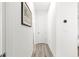 Neutral hallway with gray wood floors and white walls at 10589 Sw 98Th Ln, Ocala, FL 34481