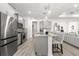 Well-lit kitchen features gray cabinets, granite countertops, stainless appliances, and an island with seating at 10589 Sw 98Th Ln, Ocala, FL 34481