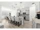 Well-lit kitchen features gray cabinets, granite countertops, stainless appliances, and an island with seating at 10589 Sw 98Th Ln, Ocala, FL 34481