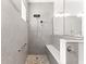 Large glass shower features gray tiling, two shower heads and pebble floor at 10589 Sw 98Th Ln, Ocala, FL 34481