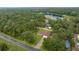 Scenic aerial view of the home surrounded by a lush green forest and lake at 1081 Se 170Th Ave, Silver Springs, FL 34488