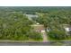 Aerial view of home nestled amongst lush trees and a nearby lake at 1081 Se 170Th Ave, Silver Springs, FL 34488