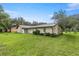 Expansive backyard with grass and patio, perfect for outdoor activities at 1081 Se 170Th Ave, Silver Springs, FL 34488
