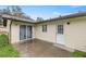 Enclosed backyard patio with sliding glass doors and a white door at 1081 Se 170Th Ave, Silver Springs, FL 34488