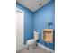 Cozy bathroom features toilet, urinal, and blue walls at 1081 Se 170Th Ave, Silver Springs, FL 34488