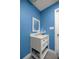 Bathroom featuring a white vanity, sink, open shelving, and a decorative mirror at 1081 Se 170Th Ave, Silver Springs, FL 34488