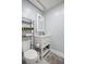 Clean bathroom features a white vanity, framed mirror, toilet, and shelving for storage at 1081 Se 170Th Ave, Silver Springs, FL 34488