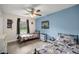 Bedroom with ceiling fan, natural light and two twin beds with decorative comforters at 1081 Se 170Th Ave, Silver Springs, FL 34488