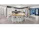 Stylish kitchen with white cabinets, island seating, gold-tone countertops, and views to the open living spaces at 1081 Se 170Th Ave, Silver Springs, FL 34488