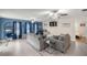 Spacious living room with blue accent wall, neutral furnishings, tile flooring, and views into adjacent rooms at 1081 Se 170Th Ave, Silver Springs, FL 34488
