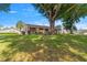 Lush backyard with mature trees providing shade, complemented by a well-manicured lawn and serene atmosphere at 10833 Sw 86Th Ter, Ocala, FL 34481