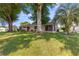 Expansive backyard featuring mature trees, lush lawn, and a screened-in lanai for outdoor enjoyment at 10833 Sw 86Th Ter, Ocala, FL 34481