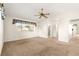 Spacious carpeted bedroom with a ceiling fan and access to bathroom and a large window at 10833 Sw 86Th Ter, Ocala, FL 34481