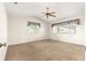Spacious bedroom featuring neutral carpet, fan, vaulted ceilings, and windows with pleasant natural light at 10833 Sw 86Th Ter, Ocala, FL 34481
