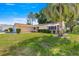Well-maintained home boasts a manicured lawn, lush shrubbery, and a stately palm tree at 10833 Sw 86Th Ter, Ocala, FL 34481
