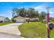 Inviting home with a well-manicured front yard, a long driveway, and tasteful landscaping at 10833 Sw 86Th Ter, Ocala, FL 34481