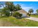 Exterior side view of a single-story home with a lush lawn and trimmed shrubbery at 10833 Sw 86Th Ter, Ocala, FL 34481