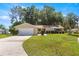 Charming single-story home with a well-maintained lawn and attached garage on a sunny day at 10833 Sw 86Th Ter, Ocala, FL 34481