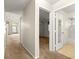 Hallway view shows access to living room, bedroom with ceiling fan, and bathroom with tiled floor at 10833 Sw 86Th Ter, Ocala, FL 34481