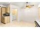 Bright kitchen with tile floors, light cabinets, and access to the laundry room at 10833 Sw 86Th Ter, Ocala, FL 34481