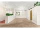 Open living room with neutral carpet and view of entry and kitchen areas at 10833 Sw 86Th Ter, Ocala, FL 34481