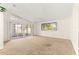 Bright living room with sliding doors to the patio and a large window at 10833 Sw 86Th Ter, Ocala, FL 34481