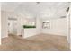 Spacious living room features carpet flooring and neutral tones, with a window view at 10833 Sw 86Th Ter, Ocala, FL 34481