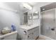Clean bathroom featuring a vanity with storage, and a glass-enclosed shower area for convenience at 10989 Sw 86Th Ave, Ocala, FL 34481
