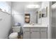 Bright bathroom featuring a vanity with storage, a toilet, and a glass-enclosed shower area for convenience at 10989 Sw 86Th Ave, Ocala, FL 34481