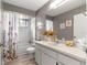 Bathroom with a bathtub, shower, toilet, and vanity with a mirror, complemented by floral decor at 10989 Sw 86Th Ave, Ocala, FL 34481