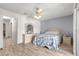 Bright bedroom featuring wood floors, a ceiling fan, and classic bedroom set with a white finish at 10989 Sw 86Th Ave, Ocala, FL 34481